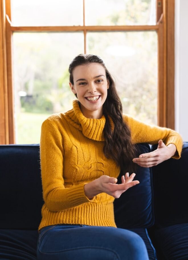 happy-caucasian-woman-sitting-on-sofa-having-video-2023-11-27-05-05-38-utc
