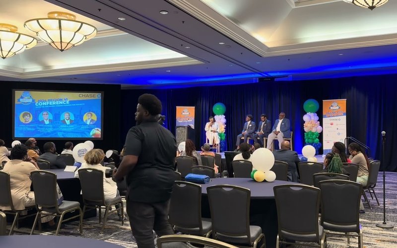 Panel on stage in a hotel ballroom at a NAREB conference